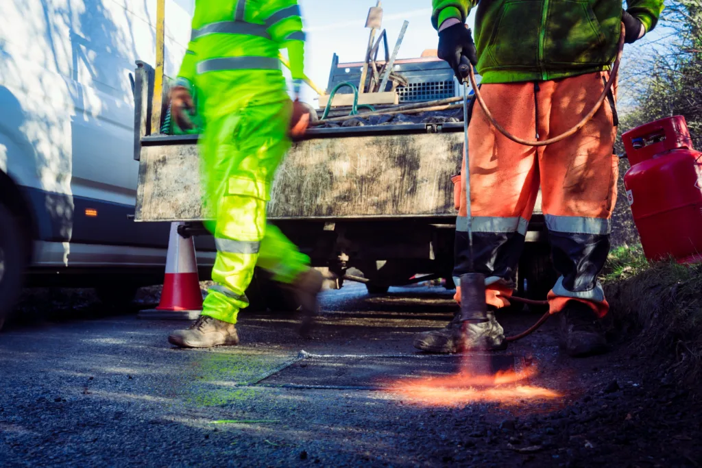 Cllr Alex Beckett, chair of the highways and transport and committee at Cambridgeshire County Council, who has been to see for himself both methods being used to resolve the county’s pothole crisis. Here looking at Dragon patchers