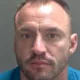 Daniel Holyoak, 39, punched the victim numerous times, stamped all over her body, dragged her around by her hair and repeatedly slammed a door into her