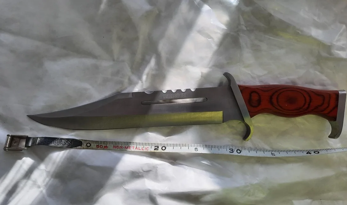 “During the search for the male, a large hunting 'RAMBO' style knife was located.