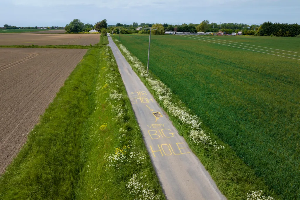 The artistic touch to draw attention to the pothole has appeared at Murrow near Wisbech and could be there for a while. PHOTO: Terry Harris for CambsNews