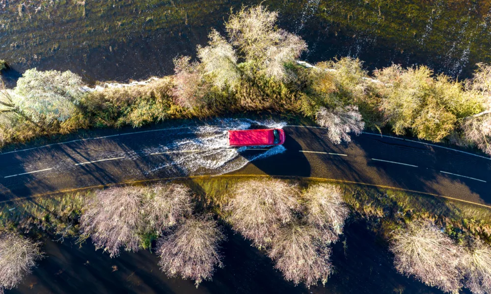 A1101 at Welney where many have chosen to find alternative routes today as water levels rise and most motorists have avoided, including those who attempted to cross but changed their mind. Bigger vehicles are still going through. PHOTO: Terry Harris for CambsNews