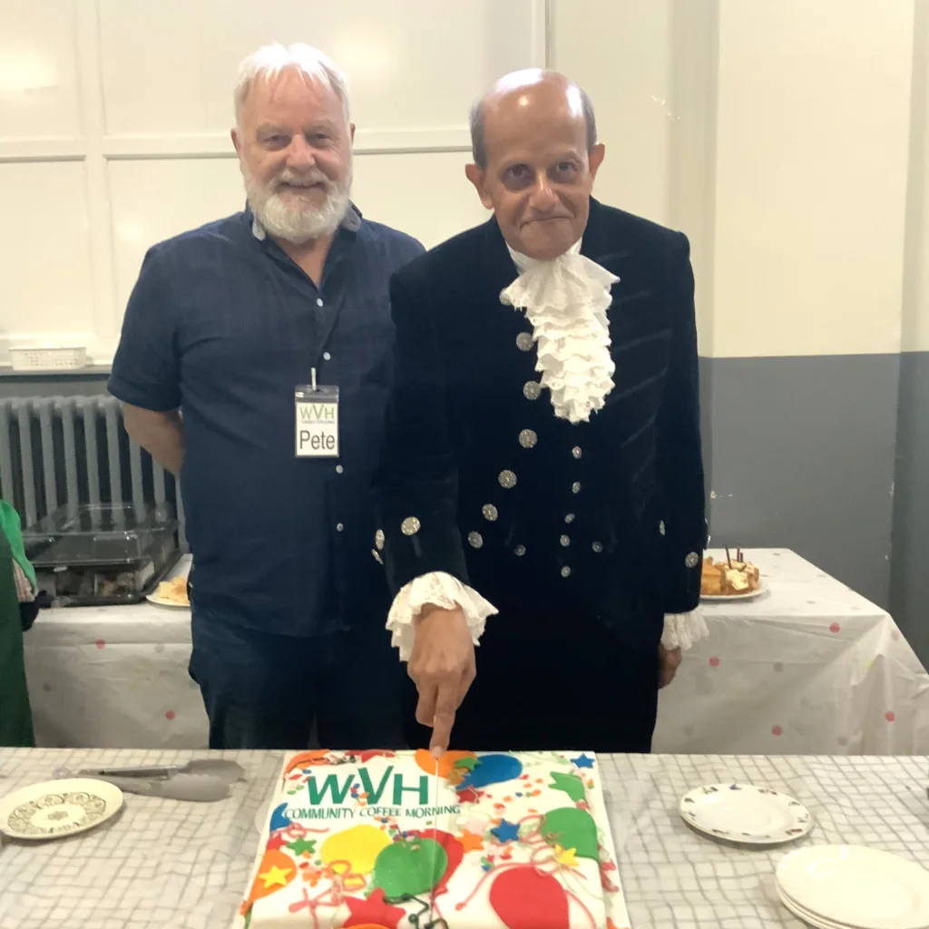 High Sheriff of Cambridgeshire, Dr Bharatkumar Khetani, cut the birthday cake as Walsoken Village Hall Community Coffee Morning celebrated its 2nd anniversary. Local police dropped in for a cuppa and cake. PHOTO: Wisbech Tweet 
