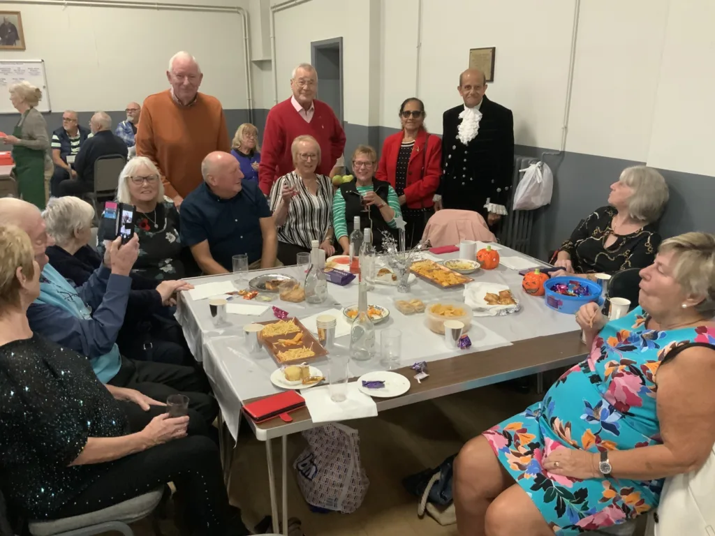 High Sheriff of Cambridgeshire, Dr Bharatkumar Khetani, cut the birthday cake as Walsoken Village Hall Community Coffee Morning celebrated its 2nd anniversary. Local police dropped in for a cuppa and cake. PHOTO: Wisbech Tweet 
