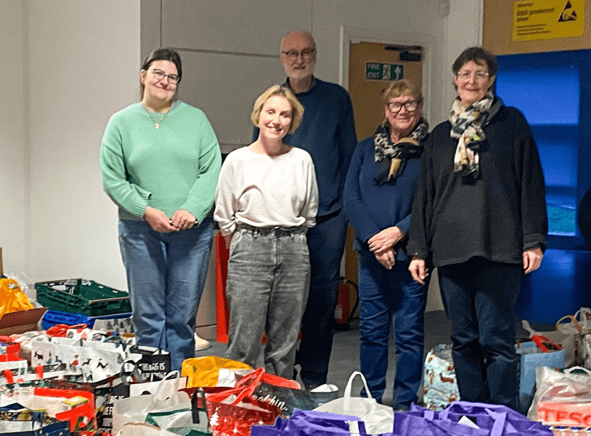 Local organiser, Kate McIntosh (L) and foodbank volunteers with donated hampers