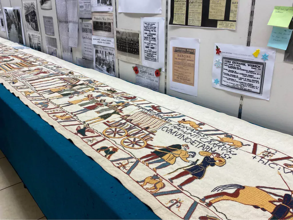 Mia Hanson took part of her Bayeux Tapestry to Wisbech Corn Exchange Conservation Trust's exhibition hall on Saturday: she was able to display almost 16 metres of tapestry. The walls were lined with photos and information about The Corn Exchange. 