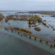 Flood water along the B1040 at Whittlesey as Storm Isha begins to batter Britain. The Environment Agency warned today that river levels at Whittlesey remain high “following a previous period of persistent rainfall in the catchment. PHOTO: Terry Harris