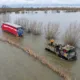 Recovery team from Manchetts were praised for their efforts in retrieving this cab and trailer that the driver was forced to abandon in the early hours of Monday on the flooded A1101 Welney Wash Road. PHOTO: Bav Media