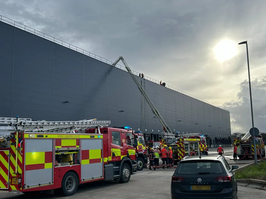 Scenes from today’s fire at the Lidl distribution depot in Peterborough. At one stage some 60 firefighters were brought in to tackle – and contain – the fire after solar panels on the roof caught fire. PHOTOS: Terry Harris for CambsNews and Cambridgeshire Fire and Rescue 