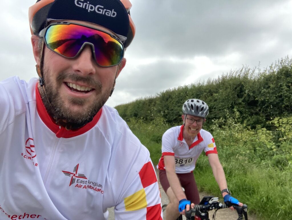 Keiran Williams (L) and Adam Clarke (R) at the Norwich 100 riding in East Anglian Air Ambulance kit