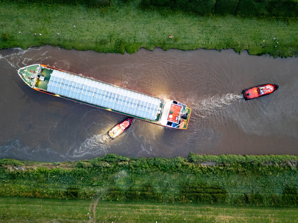 Spectators gathered by the River Nene in Wisbech as the Baltic Arrow, with its cargo of timber from Latvia, was finally freed and pulled into port. PHOTO: Terry Harris 