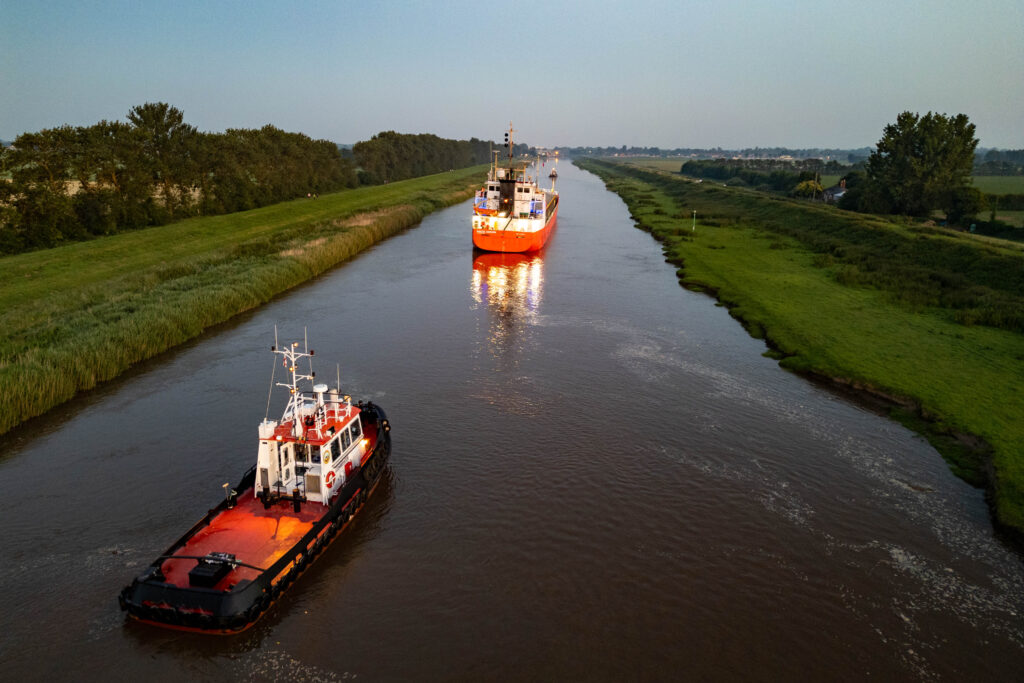 Spectators gathered by the River Nene in Wisbech as the Baltic Arrow, with its cargo of timber from Latvia, was finally freed and pulled into port. PHOTO: Terry Harris 