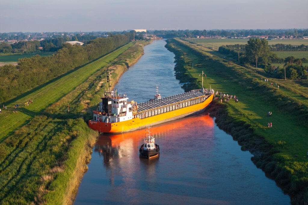 Spectators gathered by the River Nene in Wisbech as the Baltic Arrow, with its cargo of timber from Latvia, was finally freed and pulled into port. PHOTO: Terry Harris 