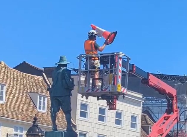 Workman removes the traffic cone from the statue of Oliver Cromwell in St Ives